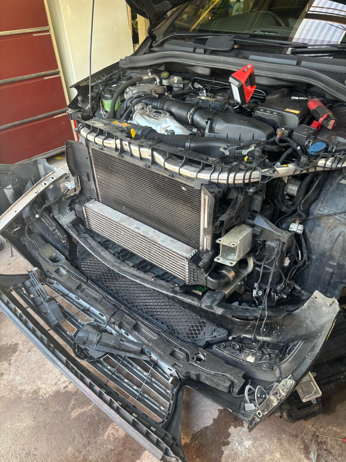 Arthur Tarakjian of North Shore Radiators installing new radiator in Mercedes Benz AMG 